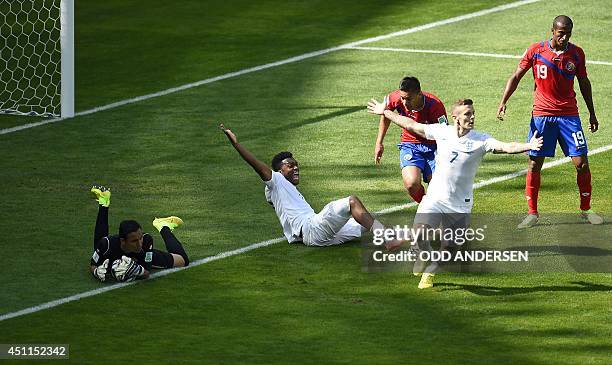 England's forward Daniel Sturridge sits on the pitch as he appeals with teammate England's midfielder Jack Wilshere as Costa Rica's defender Roy...