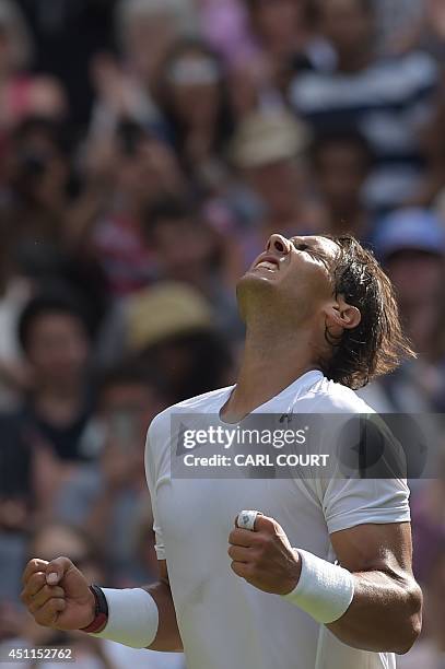 Spain's Rafael Nadal celebrates beating Slovakia's Martin Klizan during their men's singles first round match on day two of the 2014 Wimbledon...