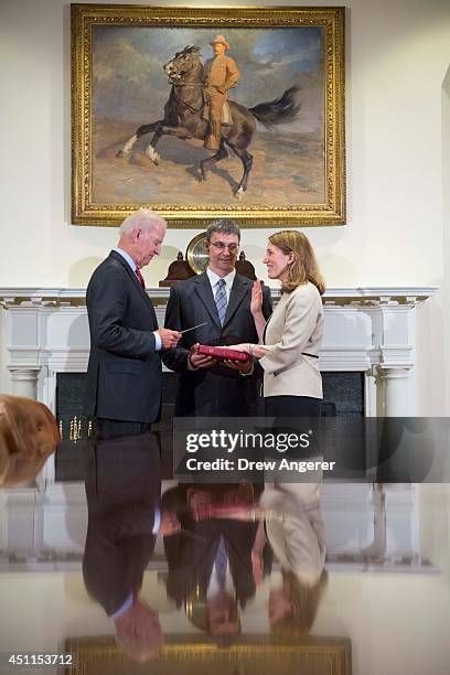 Vice President Joe Biden participates in a ceremonial swearing-in event with new Health and Human Services Secretary Sylvia Burwell and her husband...