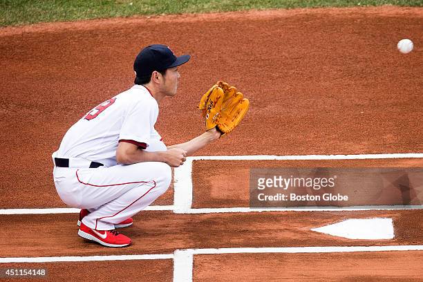 Red Sox closer Koji Uehara finds himself in an unusual position, catching a ceremonial pitch from the Japanese Consul General in Boston, Akira Muto,...