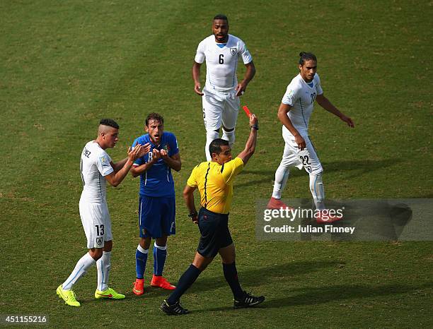 Referee Marco Rodriguez shows a red card to Claudio Marchisio of Italy during the 2014 FIFA World Cup Brazil Group D match between Italy and Uruguay...