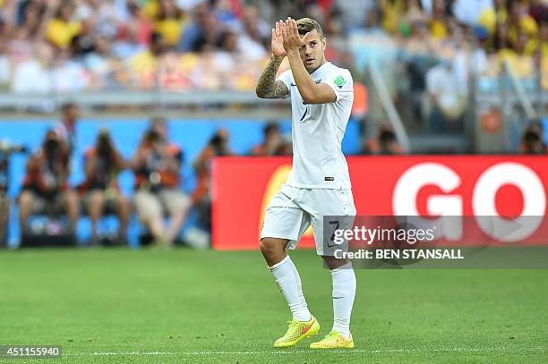 England's midfielder Jack Wilshere applauds the crowd after he is substituted by England's midfielder and captain Steven Gerrard during the Group D...