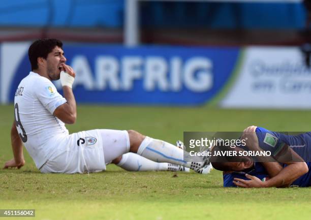 Uruguay's forward Luis Suarez reacts past Italy's defender Giorgio Chiellini during a Group D football match between Italy and Uruguay at the Dunas...