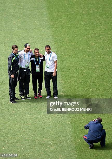 Iran's goalkeepers Daniel Davari , Alireza Haghighi , Rahman Ahmadi and US goalkeeper's coach Dan Gaspar pose for a picture as their team visits at...