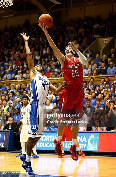 Rodney Hood of the Duke Blue Devils guards Jake Belford of the Davidson Wildcats during their game at Cameron Indoor Stadium on November 8, 2013 in...