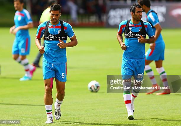 Amir Hossein Sadeghi and Mehrdad pouladi of iran look on during the Iranian training session on June 24, 2014 in Salvador, Brazil.