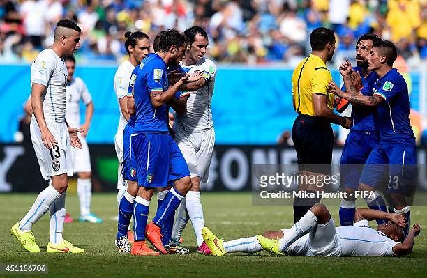Egidio Arevalo Rios of Uruguay lies injured prior to Claudio Marchisio of Italy being shown a red card during the 2014 FIFA World Cup Brazil Group D...