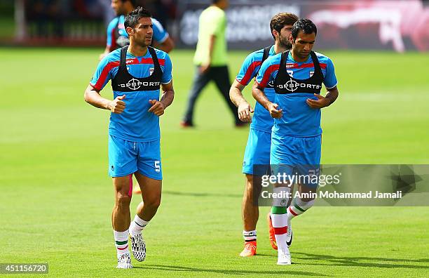 Amir Hossein Sadeghi and Mehrdad pouladi of iran look on during the Iranian training session on June 24, 2014 in Salvador, Brazil.