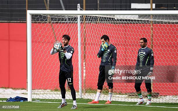 Iran's goalkeepers Alireza Haghighi, Daniel Davari and Rahman Ahmadi take part in a training session at Manoel Barradas stadium in Salvador on June...