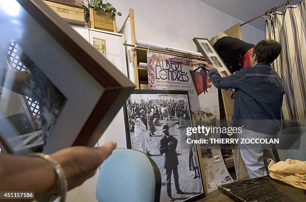 Volunteers display posters and pictures of late French journalist Albert Londres in the office of their association dedicated to the Vichy's...