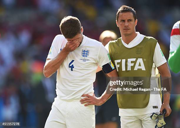 Steven Gerrard of England reacts and is consoled by teammate Phil Jagielka during the 2014 FIFA World Cup Brazil Group D match between Costa Rica and...