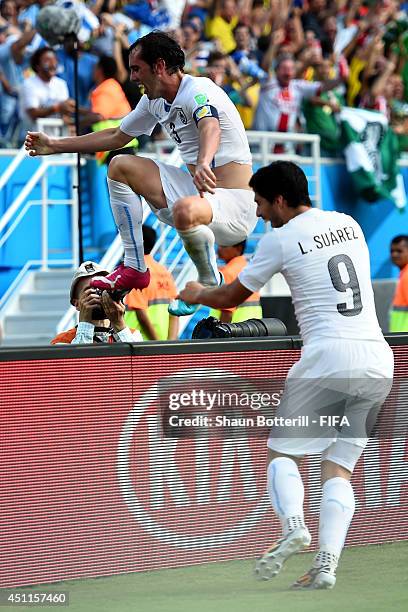 Diego Godin of Uruguay celebrates scoring his team's firs goal with his teammate Luis Suarez during the 2014 FIFA World Cup Brazil Group D match...