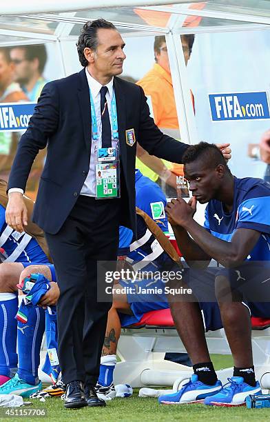 Head coach Cesare Prandelli of Italy consoles Mario Balotelli during the 2014 FIFA World Cup Brazil Group D match between Italy and Uruguay at...