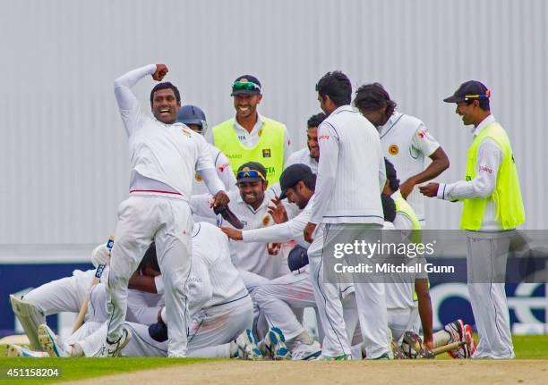 Angelo Mathews punches the air as his team celebrate winning the 2nd Investec Test Match day five between England and Sri Lanka at Headingley Cricket...