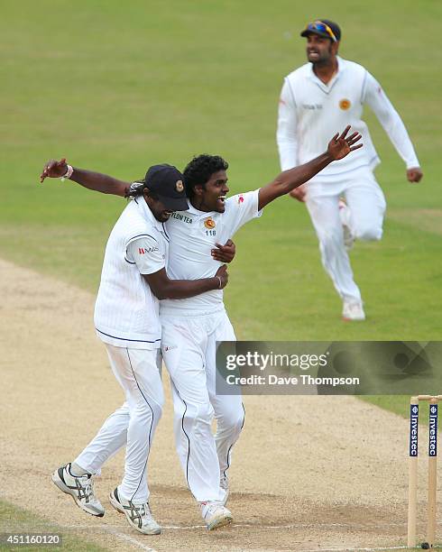 Shaminda Eranga of Sri Lanka, right, celebrates with Nuwan Pradeep of Sri Lanka after taking the wicket of James Anderson of England to win the match...