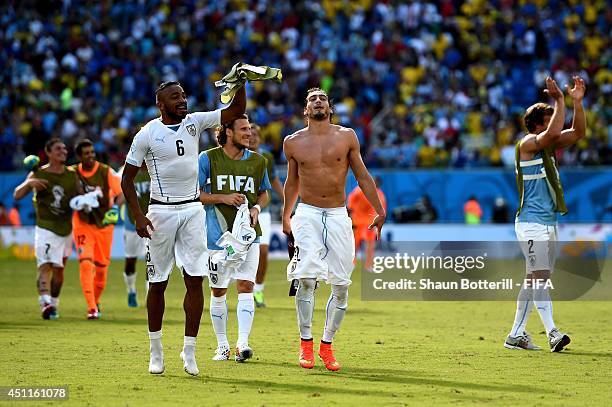 Alvaro Pereira, Diego Forlan, Martin Caceres and Diego Lugano of Uruguay celebrate the 1-0 win after the 2014 FIFA World Cup Brazil Group D match...