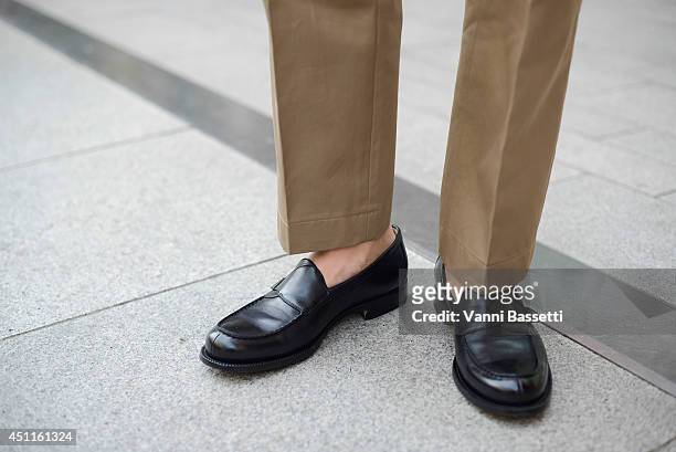 Francesco Casarotto poses in YSL pants and Ermenegildo Zegna shoes after Girgio Armani show on June 24, 2014 in Milan, Italy.