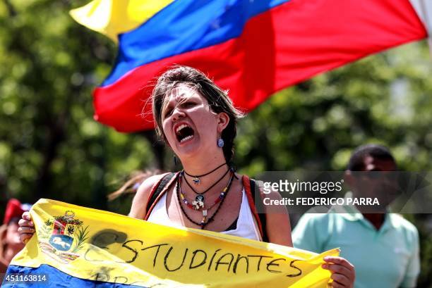 Venezuelan anti-government students shout slogans during a demo in Caracas on June 24 while the country commemorates the 193rd anniversary of the...