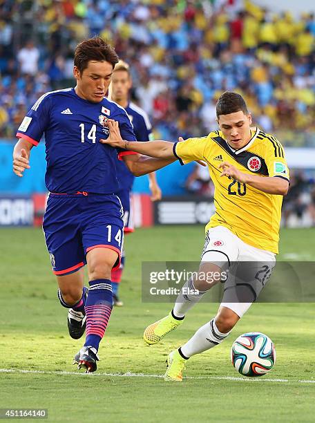 Juan Fernando Quintero of Colombia holds off Toshihiro Aoyama of Japan during the 2014 FIFA World Cup Brazil Group C match between Japan and Colombia...