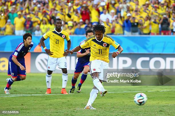 Juan Guillermo Cuadrado of Colombia shoots and scores his team's first goal on a penalty kick during the 2014 FIFA World Cup Brazil Group C match...