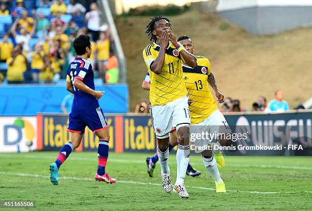 Juan Guillermo Cuadrado of Colombia celebrates scoring his team's first goal from the penalty spot during the 2014 FIFA World Cup Brazil Group C...
