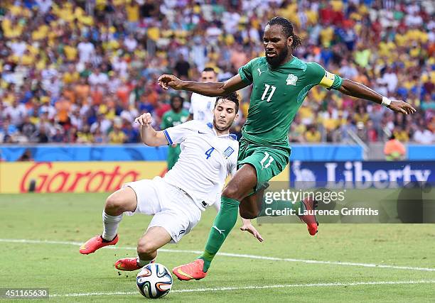 Didier Drogba of the Ivory Coast controls the ball against Konstantinos Manolas of Greece during the 2014 FIFA World Cup Brazil Group C match between...