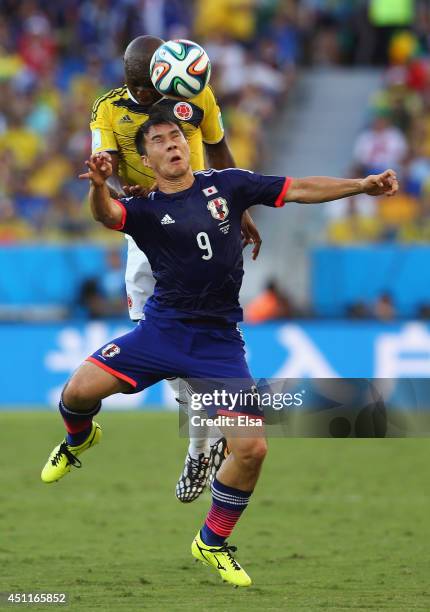 Shinji Okazaki of Japan and Pablo Armero of Colombia go up for a header during the 2014 FIFA World Cup Brazil Group C match between Japan and...