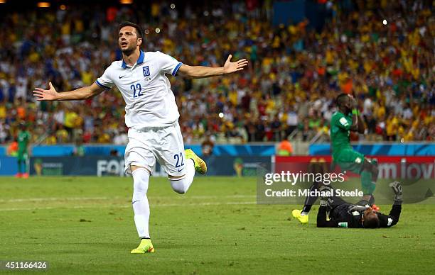 Andreas Samaris of Greece celebrates scoring his team's first goal past goalkeeper Boubacar Barry of the Ivory Coast during the 2014 FIFA World Cup...