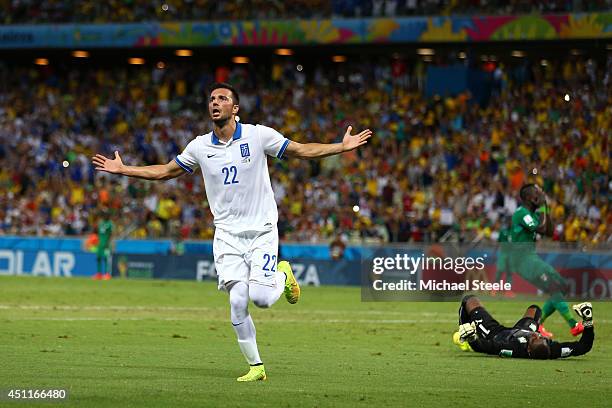 Andreas Samaris of Greece celebrates scoring his team's first goal past goalkeeper Boubacar Barry of the Ivory Coast during the 2014 FIFA World Cup...