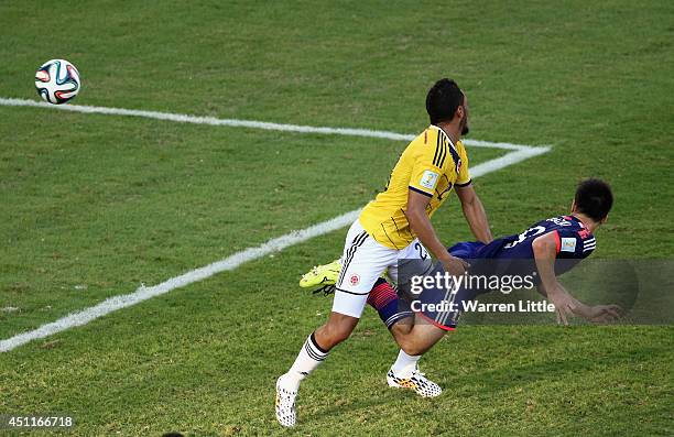 Shinji Okazaki of Japan scores his team's first goal during the 2014 FIFA World Cup Brazil Group C match between Japan and Colombia at Arena Pantanal...