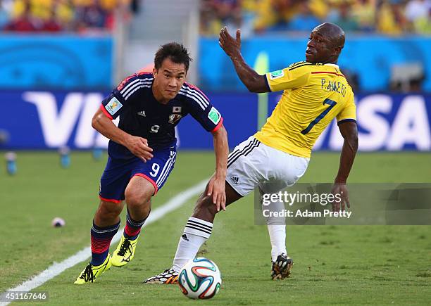 Shinji Okazaki of Japan driblbles past Pablo Armero of Colombia during the 2014 FIFA World Cup Brazil Group C match between Japan and Colombia at...