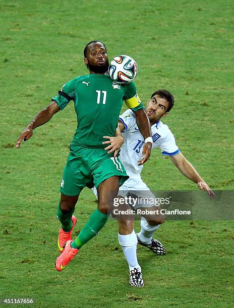 Didier Drogba of the Ivory Coast is challenged by Sokratis Papastathopoulos of Greece during the 2014 FIFA World Cup Brazil Group C match between...