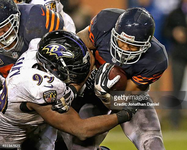 Matt Forte of the Chicago Bears is hit by Chris Canty of the Baltimore Ravens at Soldier Field on November 17, 2013 in Chicago, Illinois. The Bears...