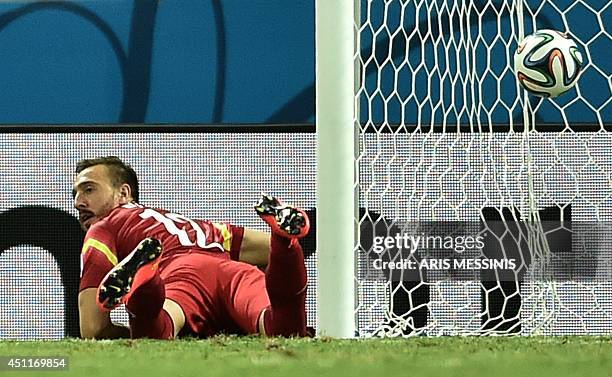 Greece's goalkeeper Panagiotis Glykos reacts after conceding a goal to Ivory Coast during the Group C football match between Greece and Ivory Coast...