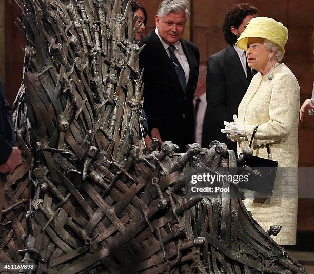 Queen Elizabeth II meets cast members of the HBO TV series 'Game of Thrones' Lena Headey and Conleth Hill as she views some of the props including...