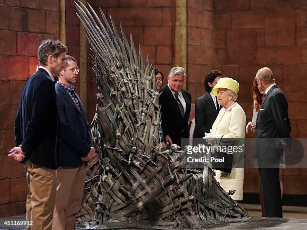 Queen Elizabeth II meets cast members of the HBO TV series 'Game of Thrones' Lena Headey and Conleth Hill as she views some of the props including...