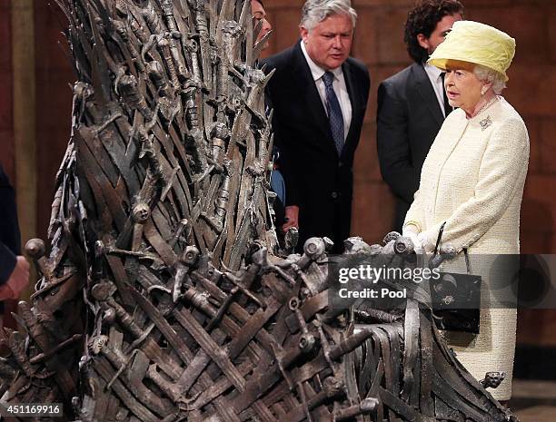 Queen Elizabeth II views the Iron Throne on the set of Game of Thrones in Belfast's Titanic Quarter on June 24, 2014 in Belfast, Northern Ireland....