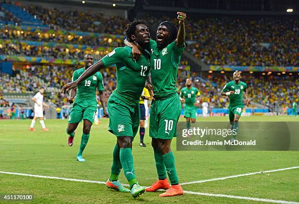 Wilfried Bony of the Ivory Coast celebrates scoring his team's first goal with Gervinho during the 2014 FIFA World Cup Brazil Group C match between...