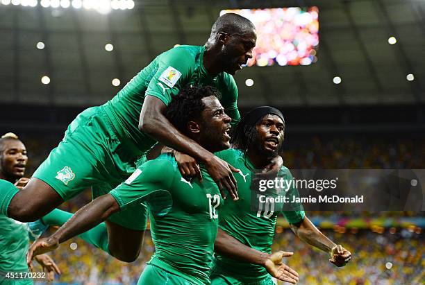 Wilfried Bony of the Ivory Coast celebrates scoring his team's first goal with Yaya Toure and Gervinho during the 2014 FIFA World Cup Brazil Group C...