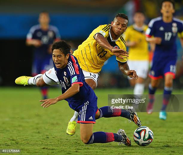 Shinji Kagawa of Japan and Fredy Guarin of Colombia compete for the ball during the 2014 FIFA World Cup Brazil Group C match between Japan and...