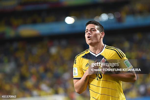 Colombia's midfielder James Rodriguez celebrates after scoring Colombia's fourth goal during the Group C football match between Japan and Colombia at...