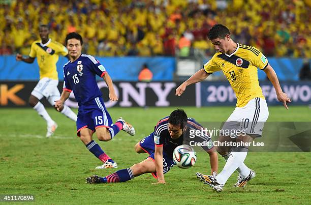 James Rodriguez of Colombia shoots and scores his team's fourth goal during the 2014 FIFA World Cup Brazil Group C match between Japan and Colombia...