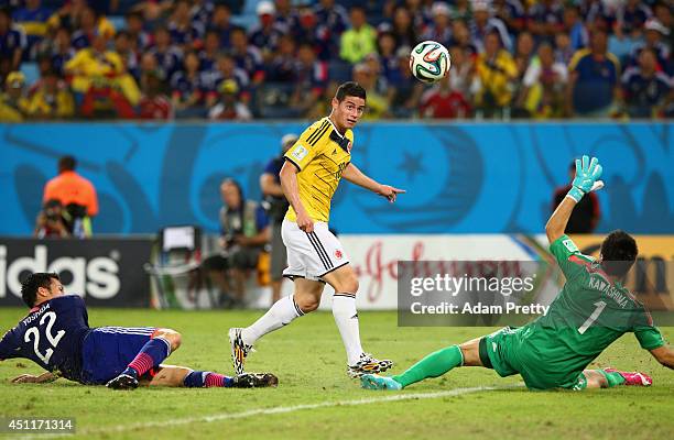 James Rodriguez of Colombia shoots and scores his team's fourth goal past goalkeeper Eiji Kawashima of Japan during the 2014 FIFA World Cup Brazil...