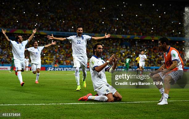 Giorgos Samaras of Greece celebrates scoring his team's second goal from the penalty spot with his teammates during the 2014 FIFA World Cup Brazil...
