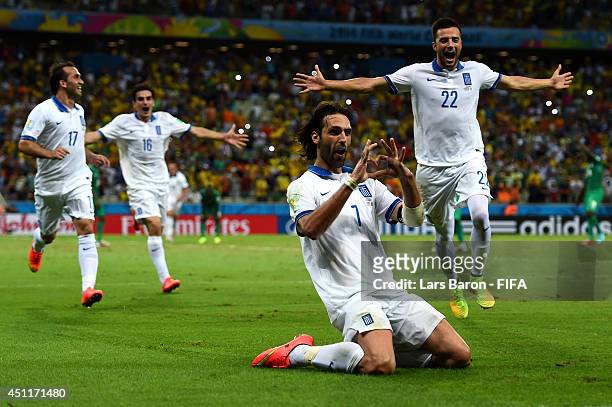 Giorgos Samaras of Greece celebrates scoring his team's second goal from the penalty spot with his teammates during the 2014 FIFA World Cup Brazil...
