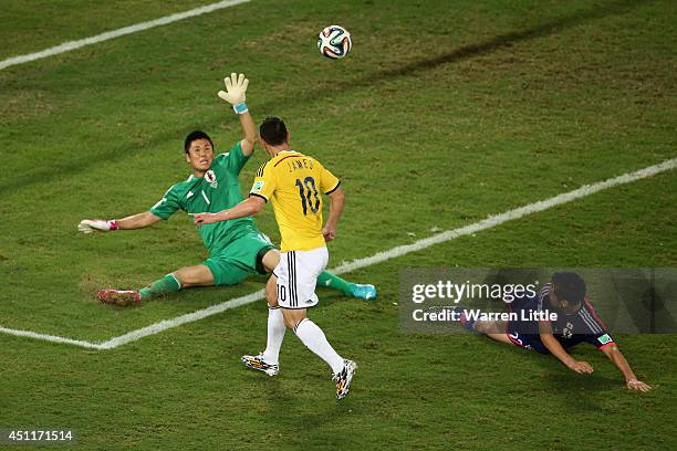 James Rodriguez of Colombia shoots and scores his team's fourth goal past goalkeeper Eiji Kawashima of Japan during the 2014 FIFA World Cup Brazil...