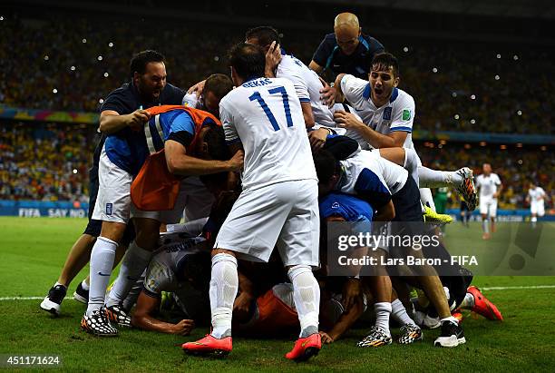 Greece players celebrate the second goal during the 2014 FIFA World Cup Brazil Group C match between Greece and Cote D'Ivoire at Estadio Castelao on...
