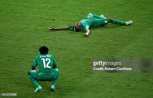 Dejected Wilfried Bony and Die Serey of the Ivory Coast react after being defeated by Greece 2-1 during the 2014 FIFA World Cup Brazil Group C match...