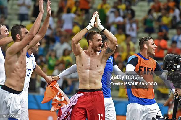 Greece's goalkeeper Panagiotis Glykos and teammates celebrate their victory after a Group C football match between Greece and Ivory Coast at the...