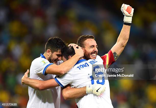 Konstantinos Manolas, Vasilis Torosidis and Panagiotis Glykos of Greece celebrate after defeating the Ivory Coast 2-1 during the 2014 FIFA World Cup...